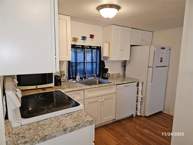 a kitchen with stainless steel appliances a refrigerator sink and cabinets