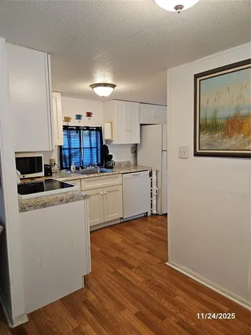 a kitchen with stainless steel appliances a refrigerator and a stove top oven
