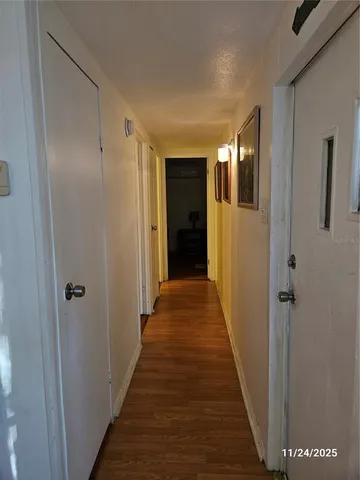 a view of a hallway with the wooden floor