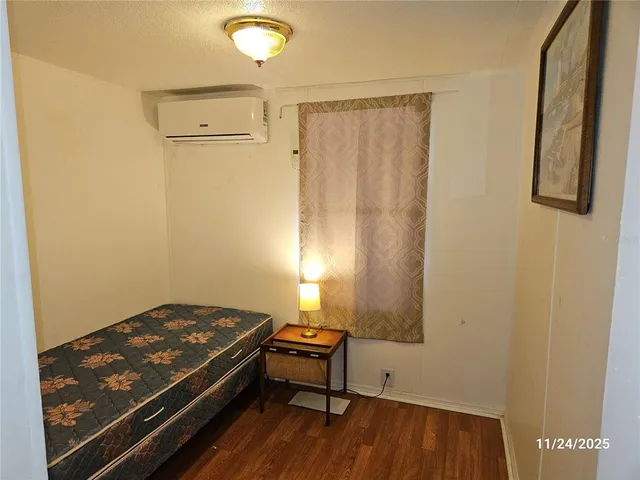 a room with wooden floor and furniture