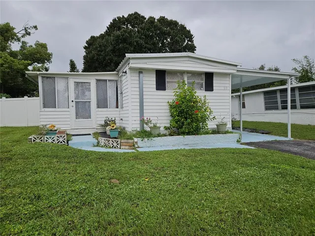 a front view of a house with a garden and porch