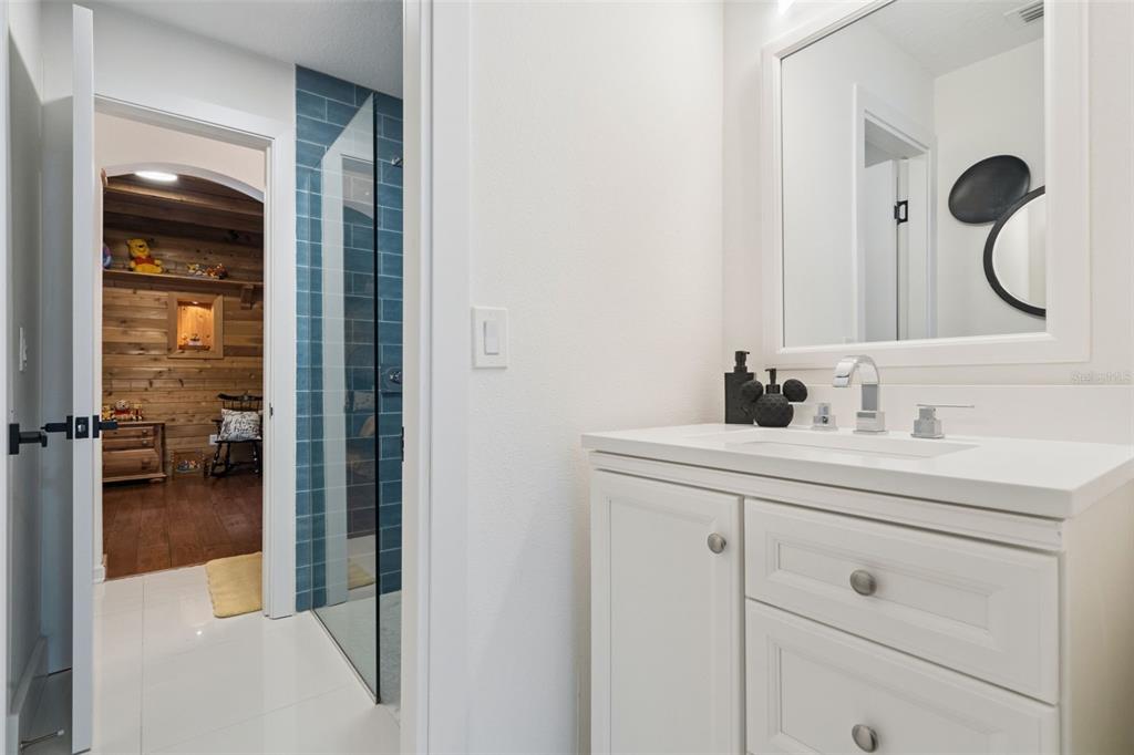 908 Croton Road Celebration, FL 34747 - Photo 40 of 86 a en suite bathroom with a sink and a mirror