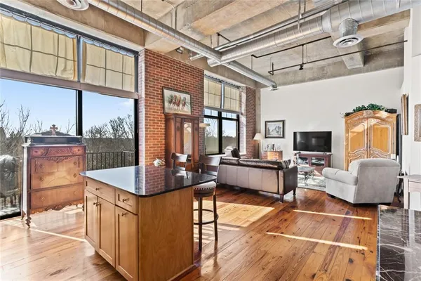 a living room with fireplace furniture and a floor to ceiling window
