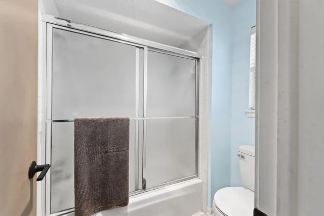 a bedroom with a bed and a chair