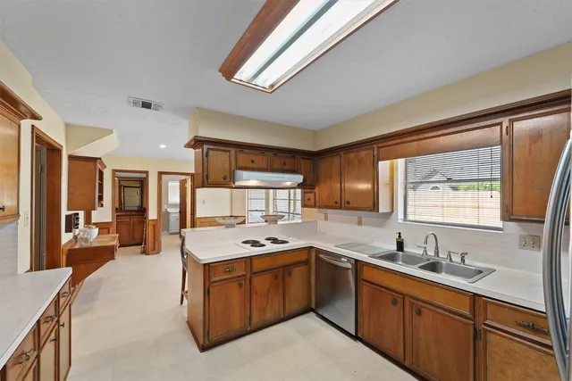 a kitchen with a stove a sink and a refrigerator