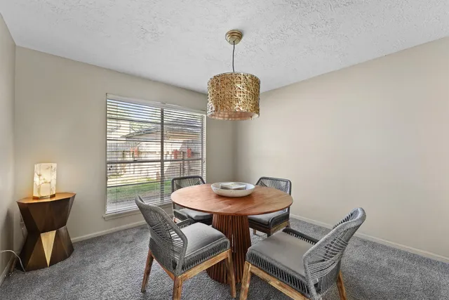 a view of a dining room with furniture wooden floor and chandelier