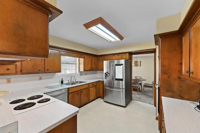 a kitchen that has a sink and a stove in it