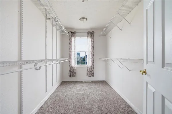 a bedroom with a balcony a bed and a chandelier