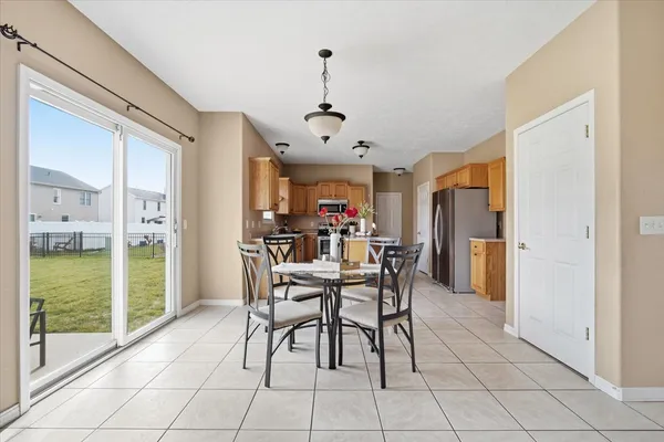 a dining room with furniture and wooden floor