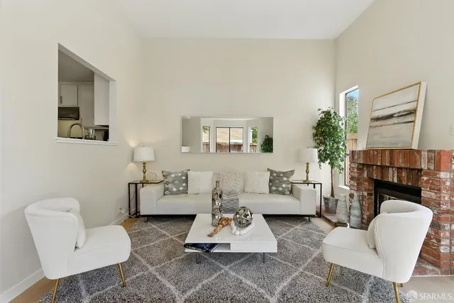 a dining room with furniture a chandelier and kitchen view