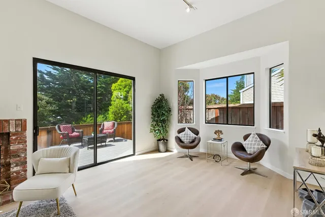 a living room with fireplace furniture and a table