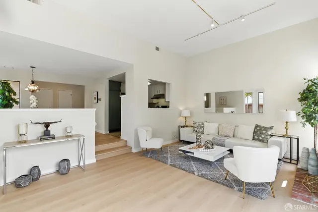 a kitchen with a refrigerator a table and chairs in it