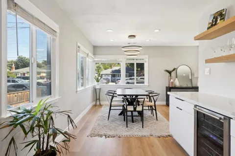 a view of a kitchen with dining table and chairs