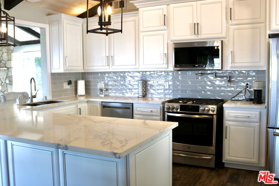 50 Rockinghorse Road Rancho Palos Verdes, CA 90275 - Photo 9 of 18 a kitchen with stainless steel appliances granite countertop a sink and a stove