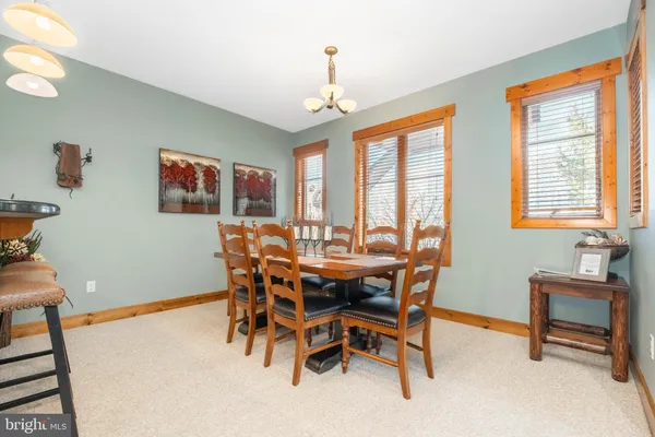 a dining room with furniture window and outside view