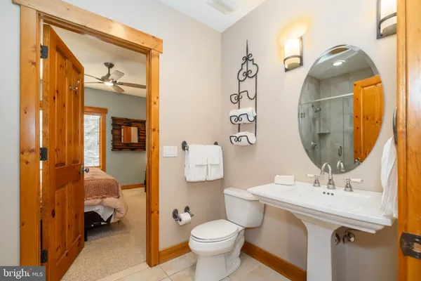 a bathroom with a toilet sink and mirror