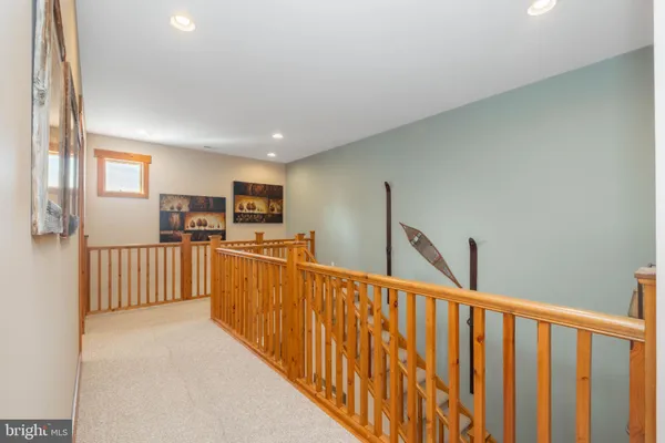 a view of a kitchen with wooden floor and stairs