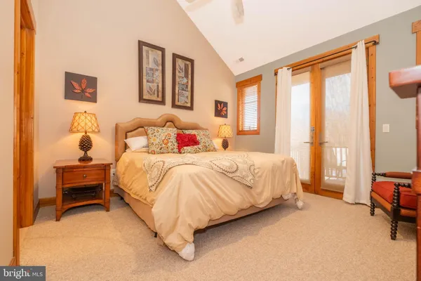 a bedroom with a bed chair and a large window