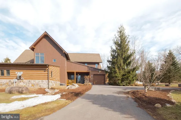 a view of a house with snow on the road