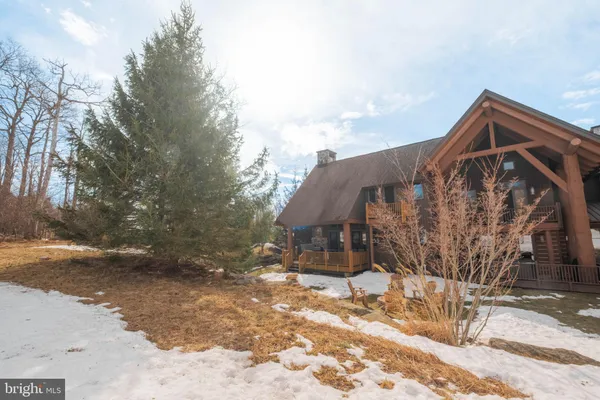 a view of a house with snow on the road