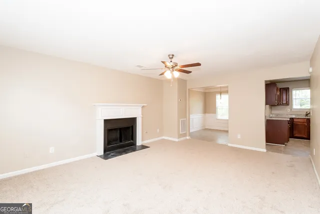 a view of an empty room with a fireplace