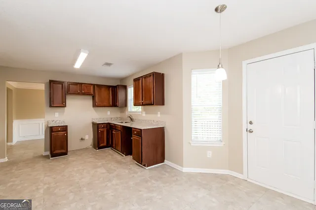 a large kitchen with cabinets and stainless steel appliances
