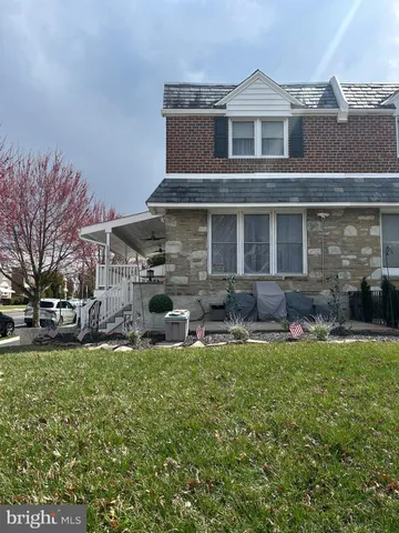 a view of a house with a yard porch and sitting area