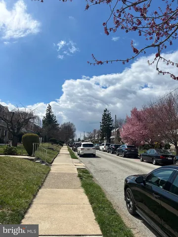 a view of a street with cars parked