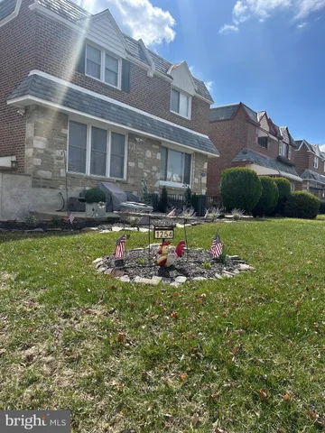 a view of a house with a big yard and potted plants