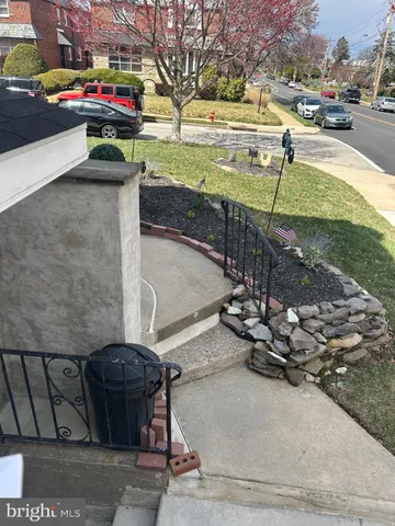 a view of a street with cars parked