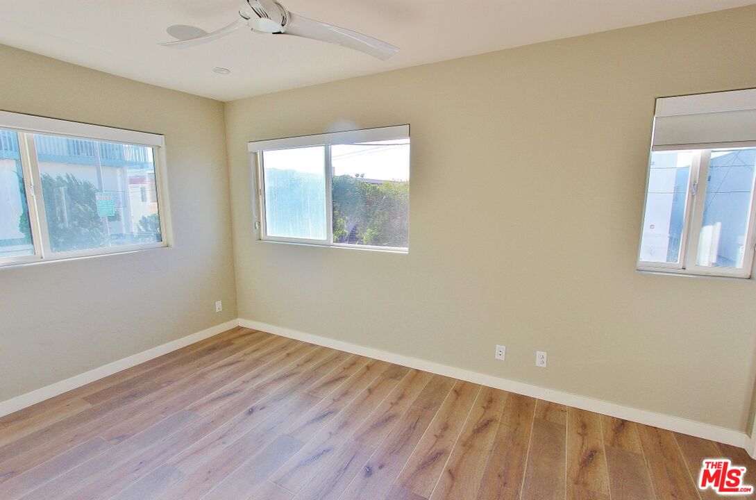 6521 Pacific Avenue Playa del Rey, CA 90293 - Photo 19 of 42 a view of an empty room with wooden floor and a window