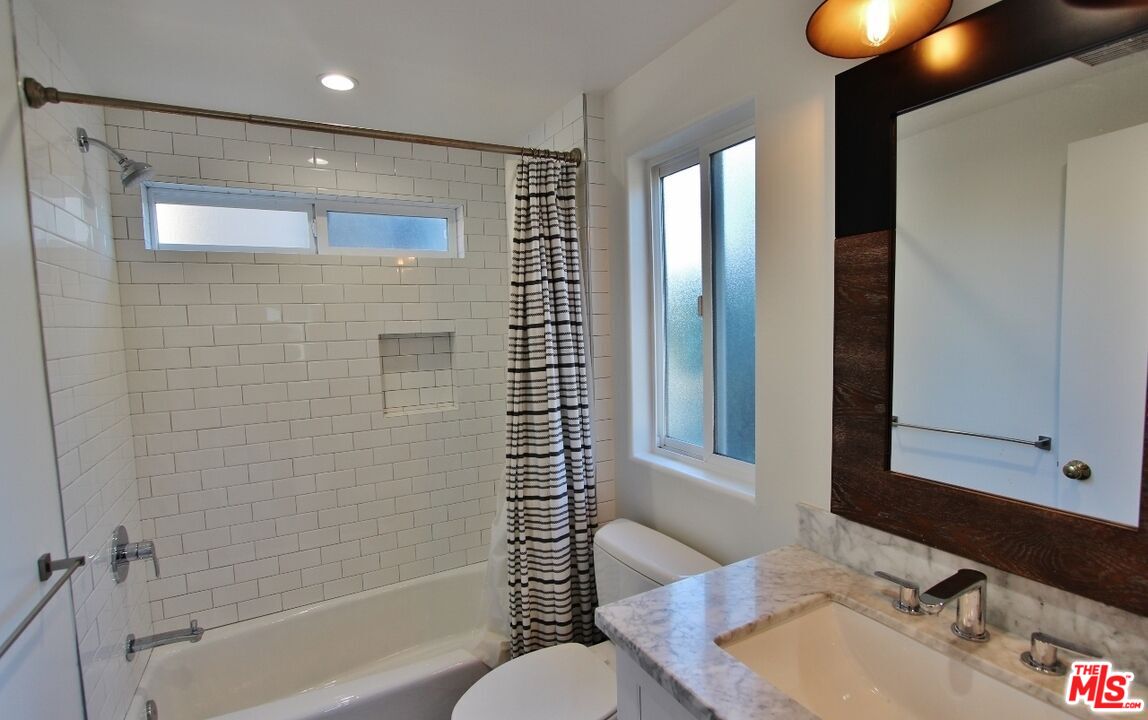 6521 Pacific Avenue Playa del Rey, CA 90293 - Photo 36 of 42 a bathroom with a granite countertop sink and a mirror