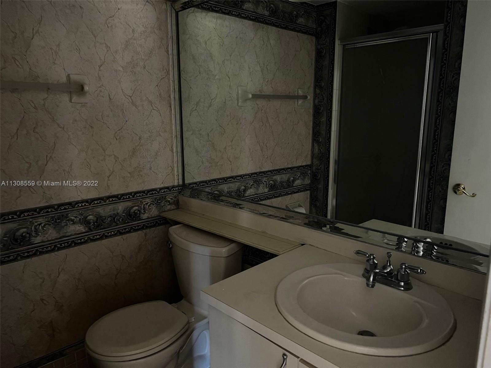 18230 Mediterranean Boulevard, Unit 113 Hialeah, FL 33015 - Photo 12 of 18 a bathroom with a sink and a toilet