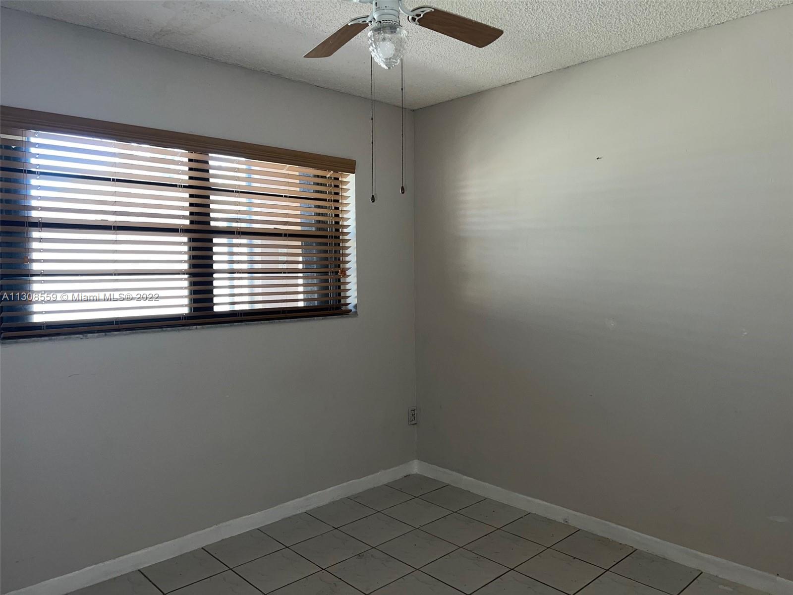 18230 Mediterranean Boulevard, Unit 113 Hialeah, FL 33015 - Photo 14 of 18 an empty room with a window
