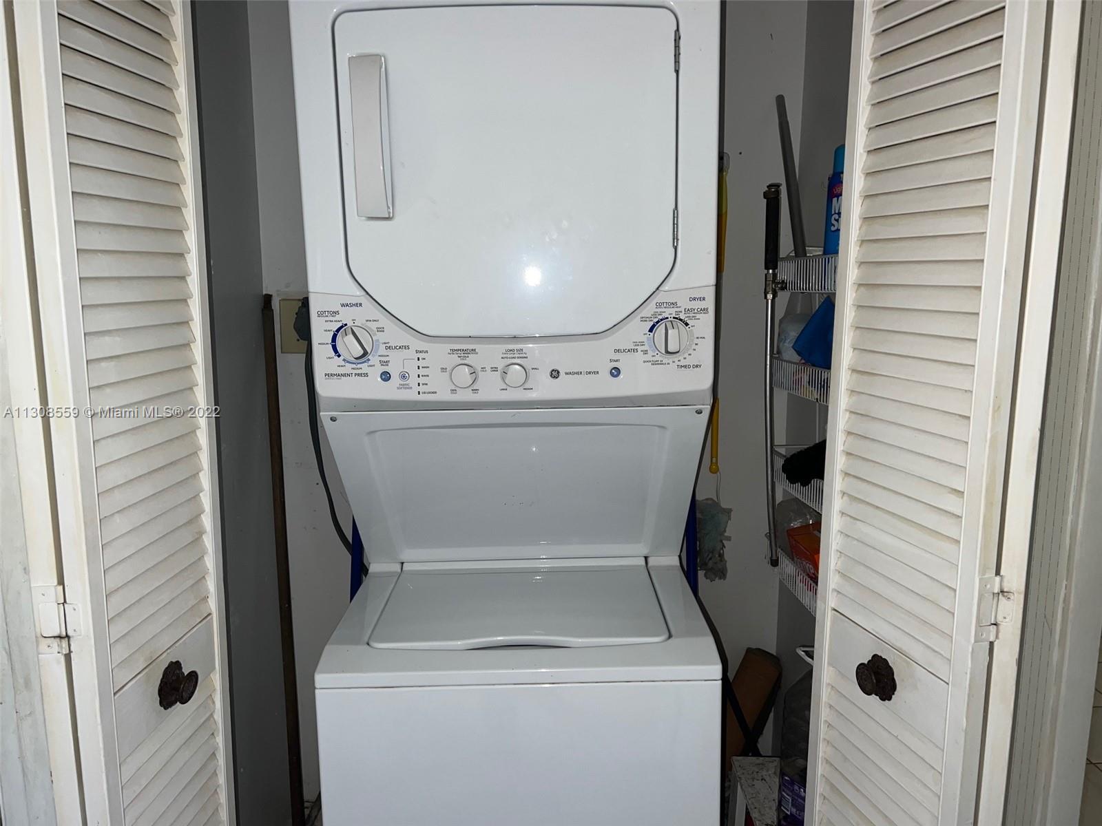 18230 Mediterranean Boulevard, Unit 113 Hialeah, FL 33015 - Photo 15 of 18 a utility room with dryer and washer