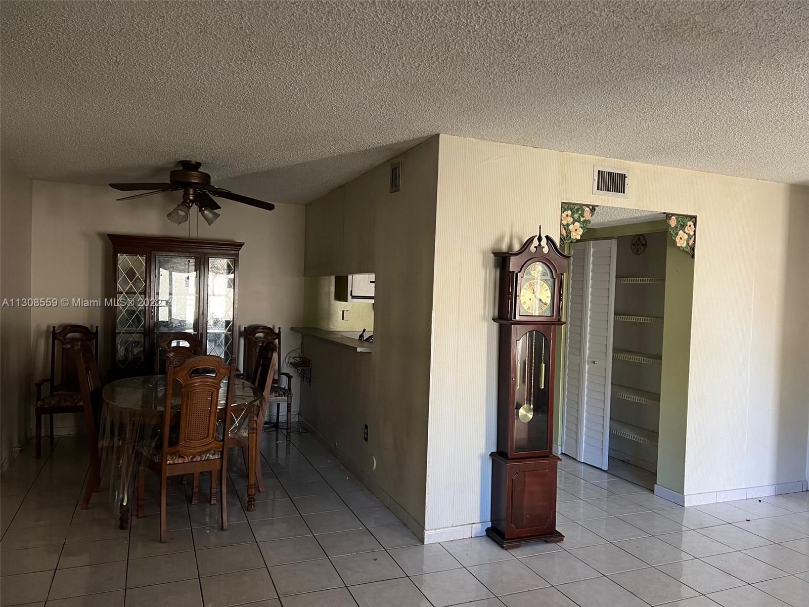 18230 Mediterranean Boulevard, Unit 113 Hialeah, FL 33015 - Photo 5 of 18 a view of a dining room with furniture