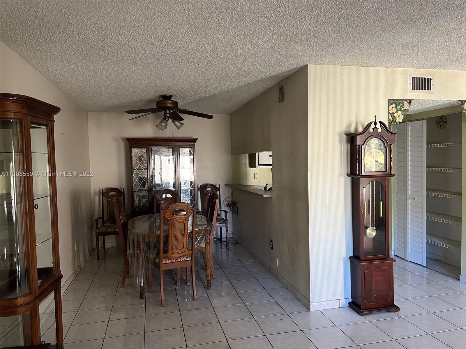 18230 Mediterranean Boulevard, Unit 113 Hialeah, FL 33015 - Photo 9 of 18 a view of a dining room with furniture