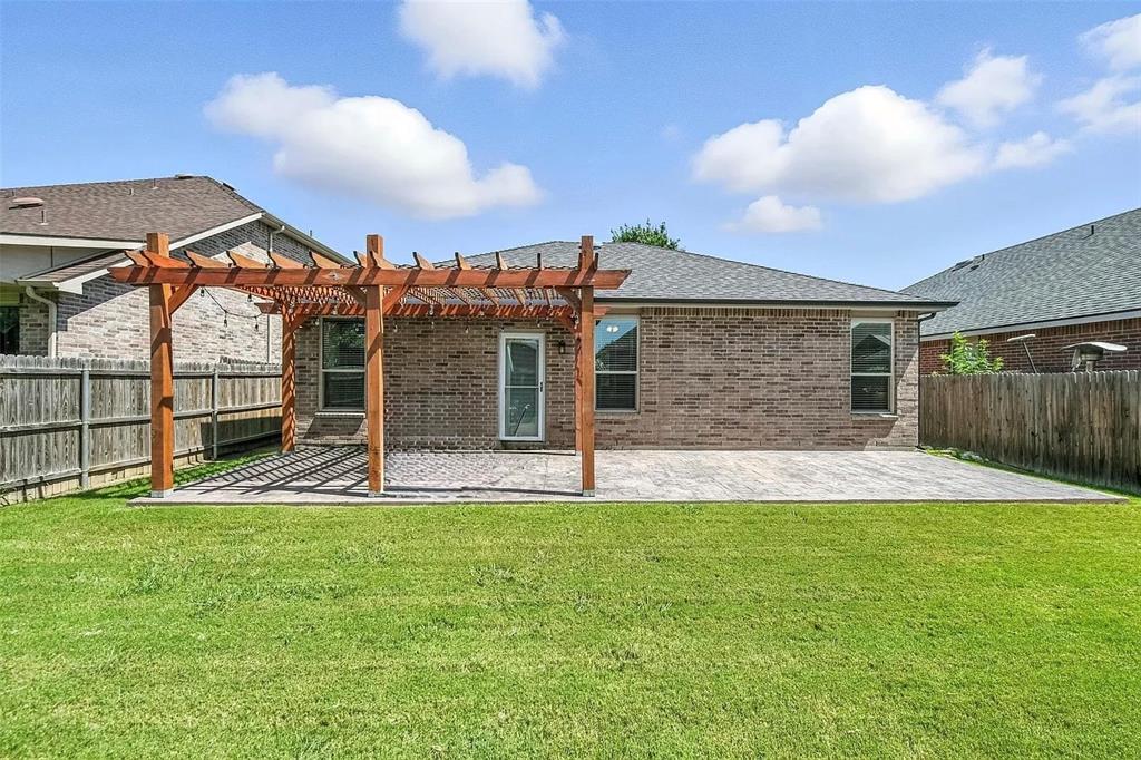 5817 Deck House Road Fort Worth, TX 76179 - Photo 15 of 19 Expansive backyard featuring a manicured lawn, a large paver patio, and a wood pergola