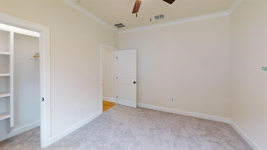 2509 Windmill Lane Longview, TX 75601 - Photo 26 of 35 Unfurnished bedroom with carpet floors, ornamental molding, and a ceiling fan