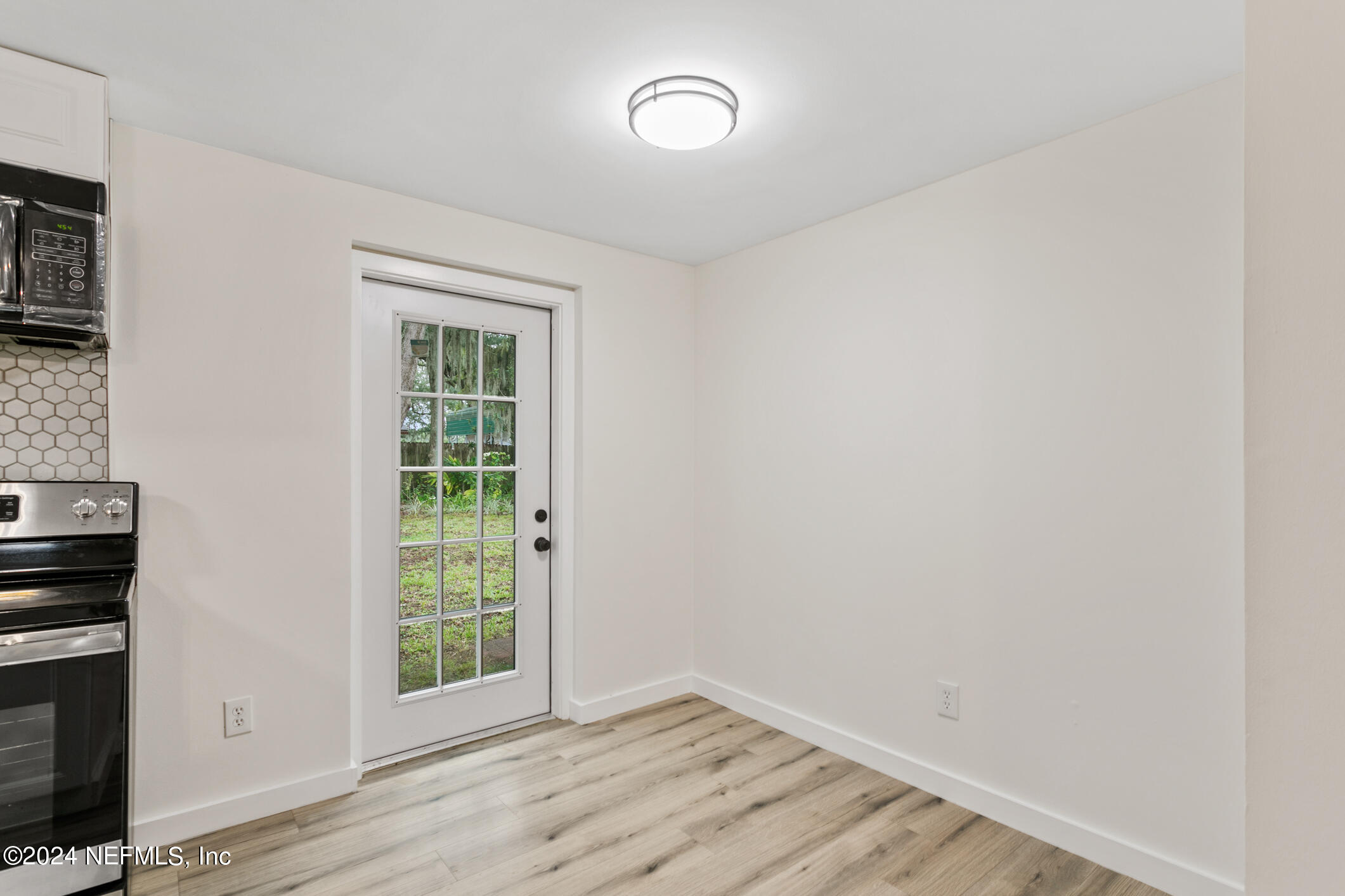 4216 Oriely Drive Jacksonville, FL 32210 - Photo 21 of 36 wooden floor in an empty room with a window