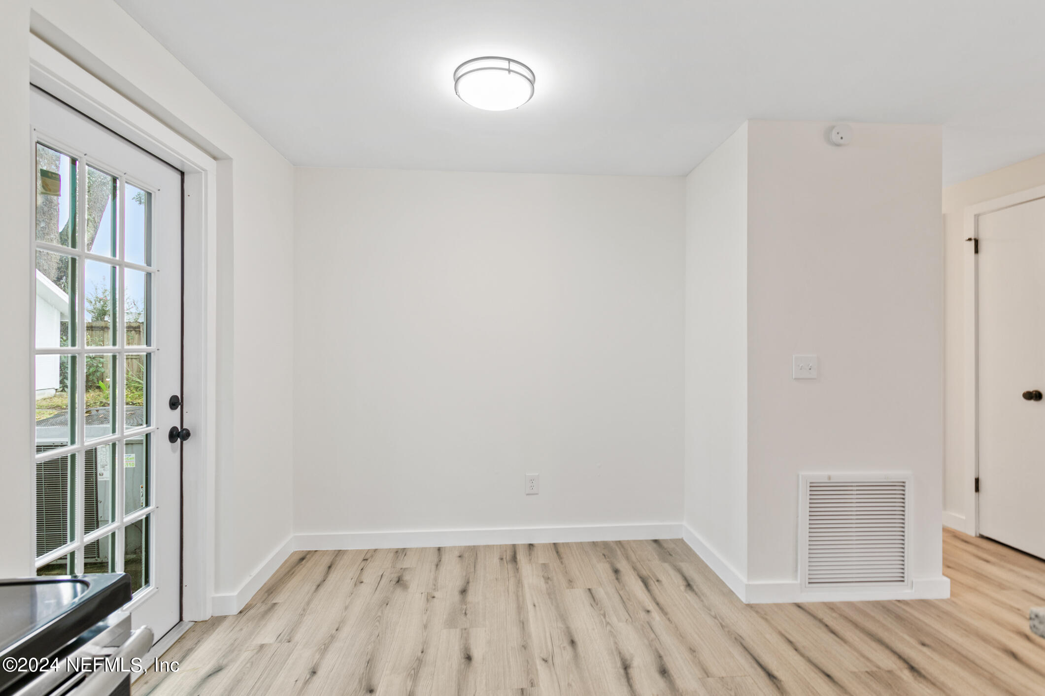 4216 Oriely Drive Jacksonville, FL 32210 - Photo 22 of 36 wooden floor in an empty room with a window