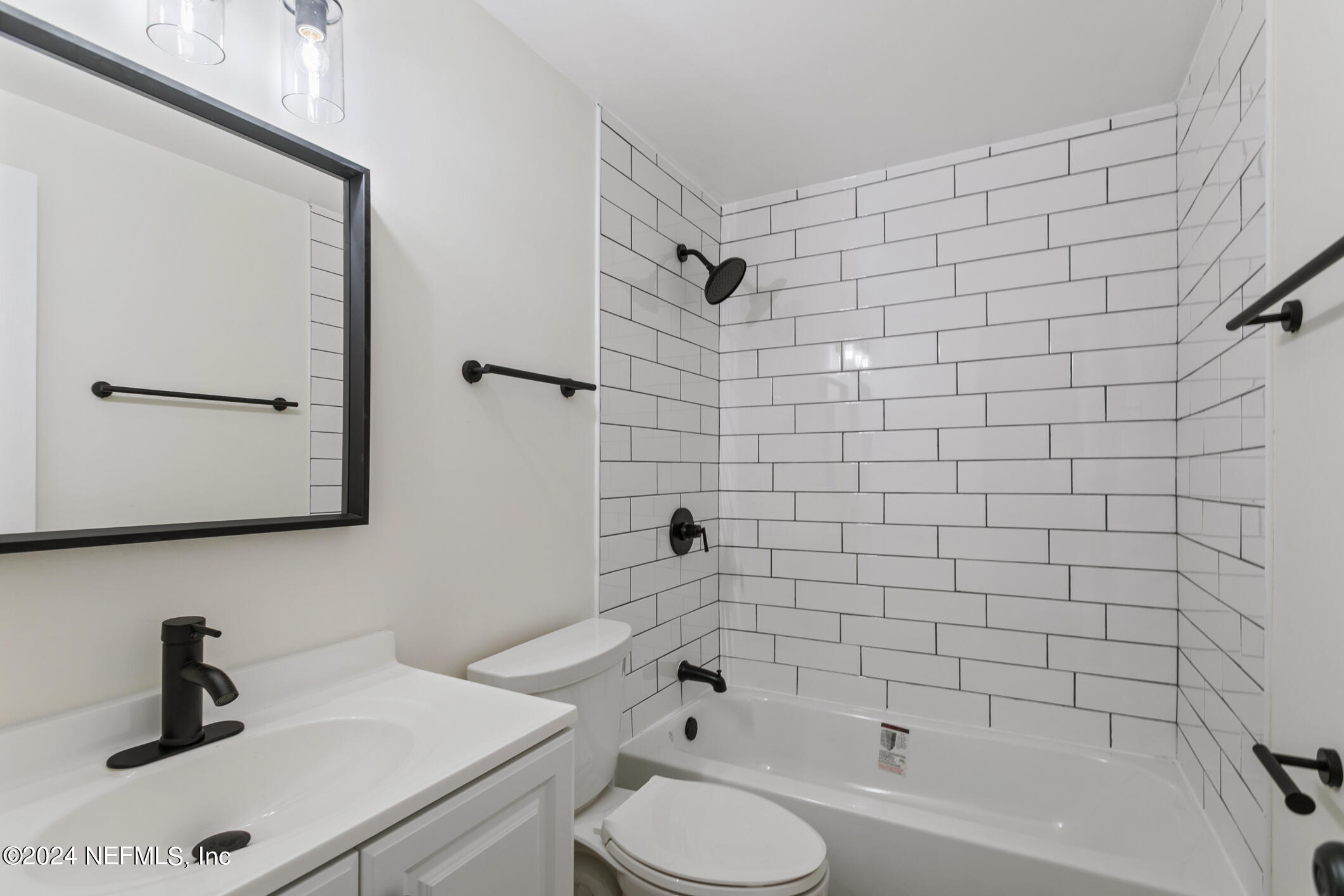 4216 Oriely Drive Jacksonville, FL 32210 - Photo 24 of 36 a bathroom with a bathtub shower sink vanity and toilet