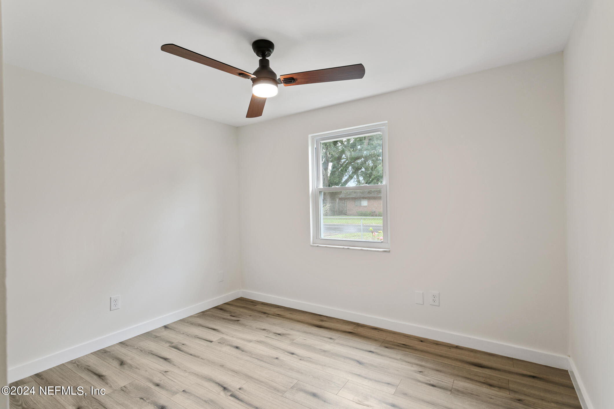 4216 Oriely Drive Jacksonville, FL 32210 - Photo 26 of 36 an empty room with a window and ceiling fan
