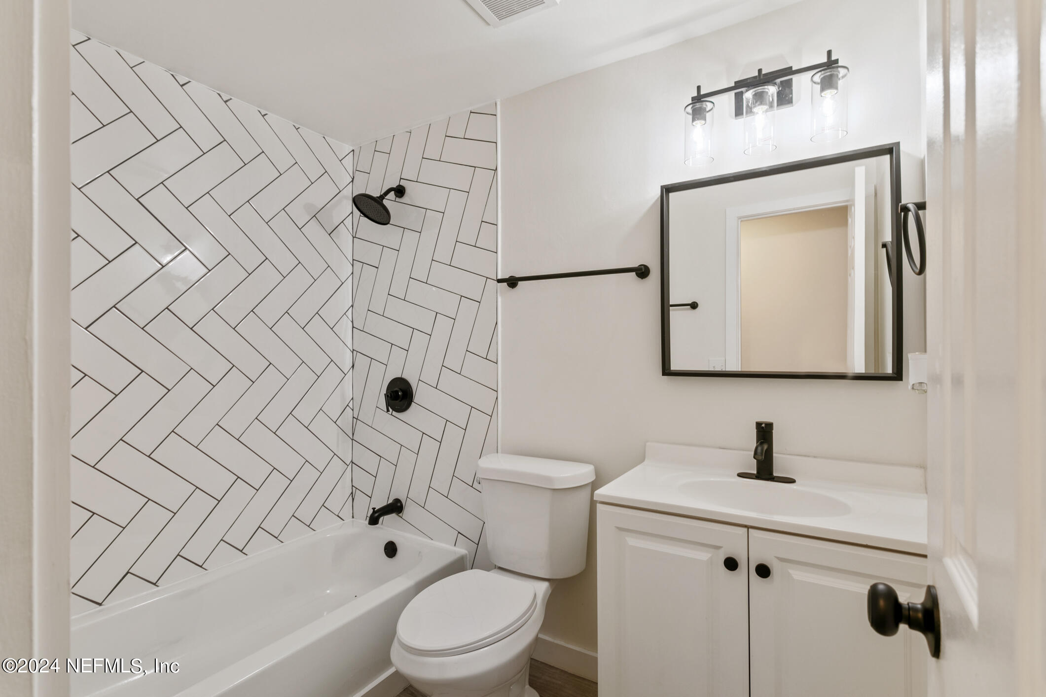 4216 Oriely Drive Jacksonville, FL 32210 - Photo 30 of 36 a bathroom with a toilet sink and mirror