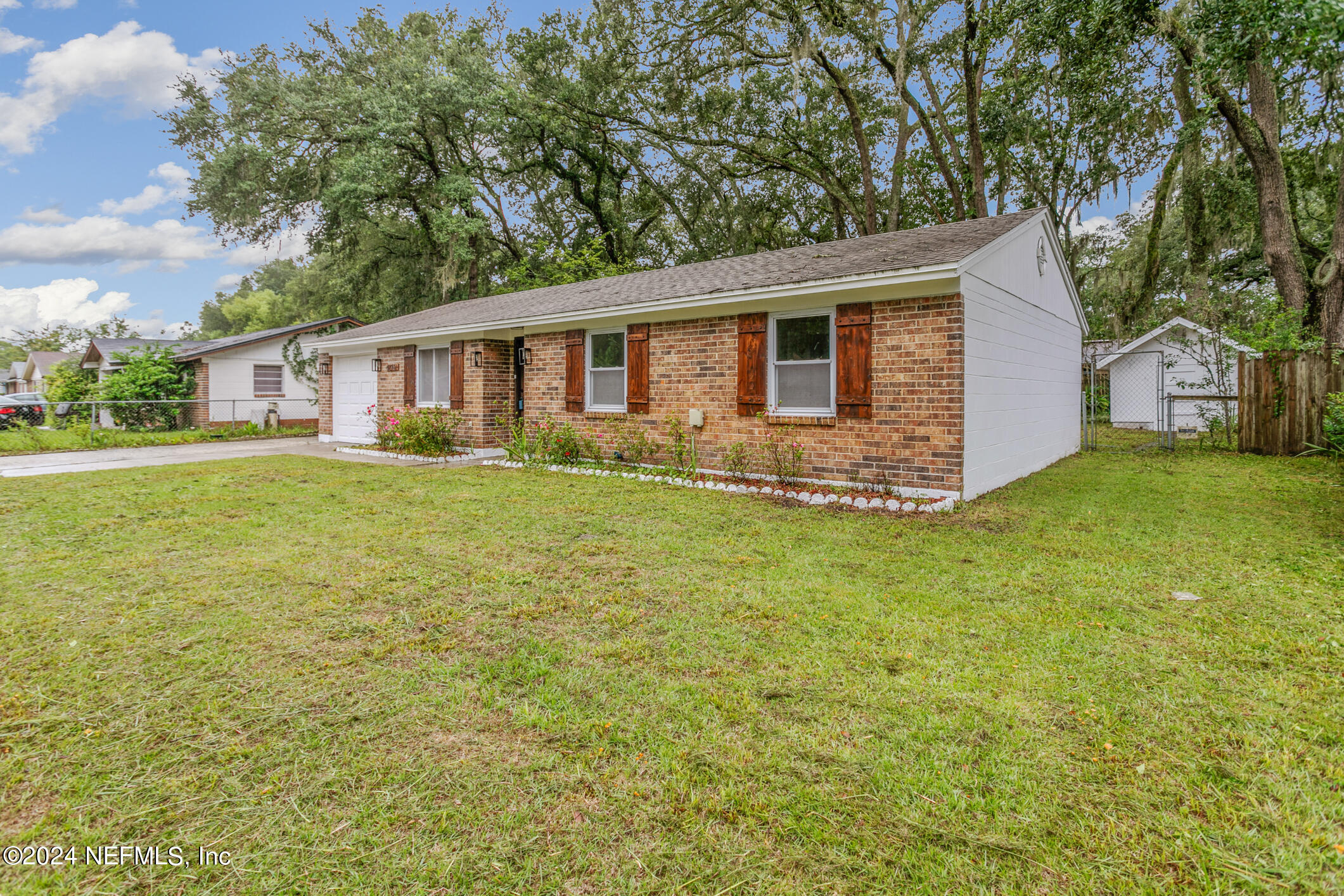 4216 Oriely Drive Jacksonville, FL 32210 - Photo 9 of 36 a front view of house with yard and trees