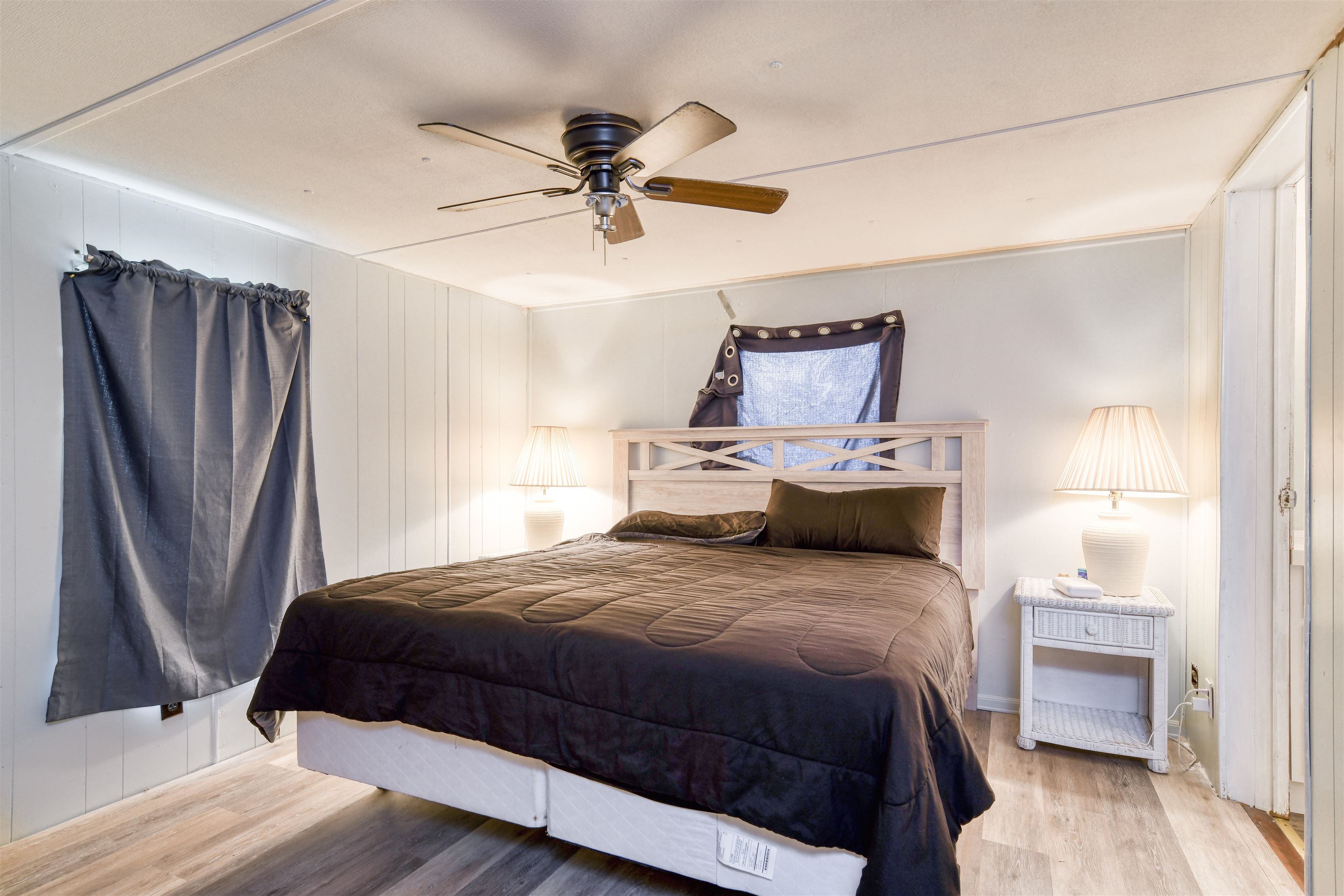 242 Basque Road St. Augustine, FL 32080 - Photo 12 of 20 a bedroom with a bed a mirror and a hardwood