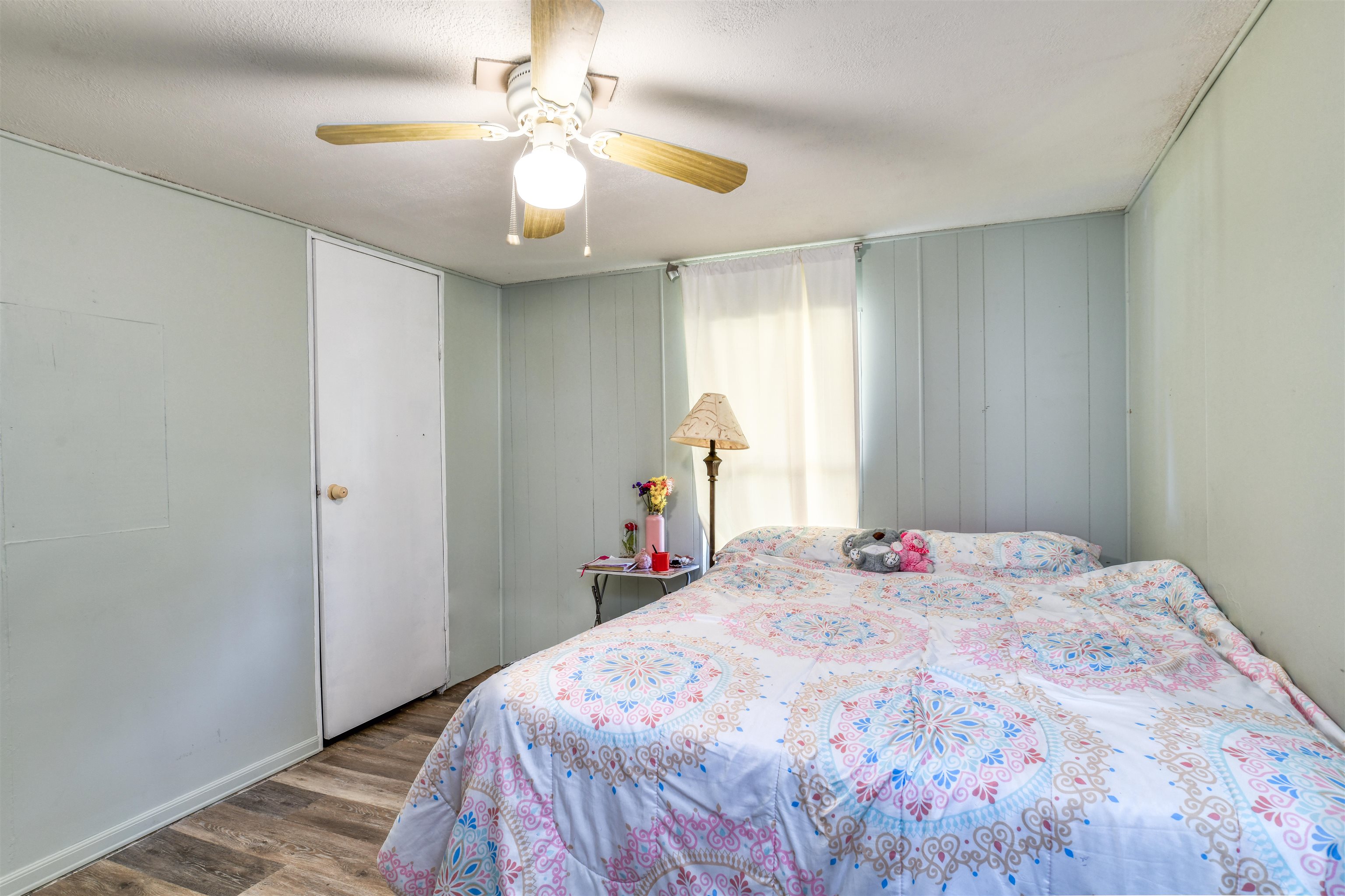 242 Basque Road St. Augustine, FL 32080 - Photo 18 of 20 a bedroom with a bed and a chandelier