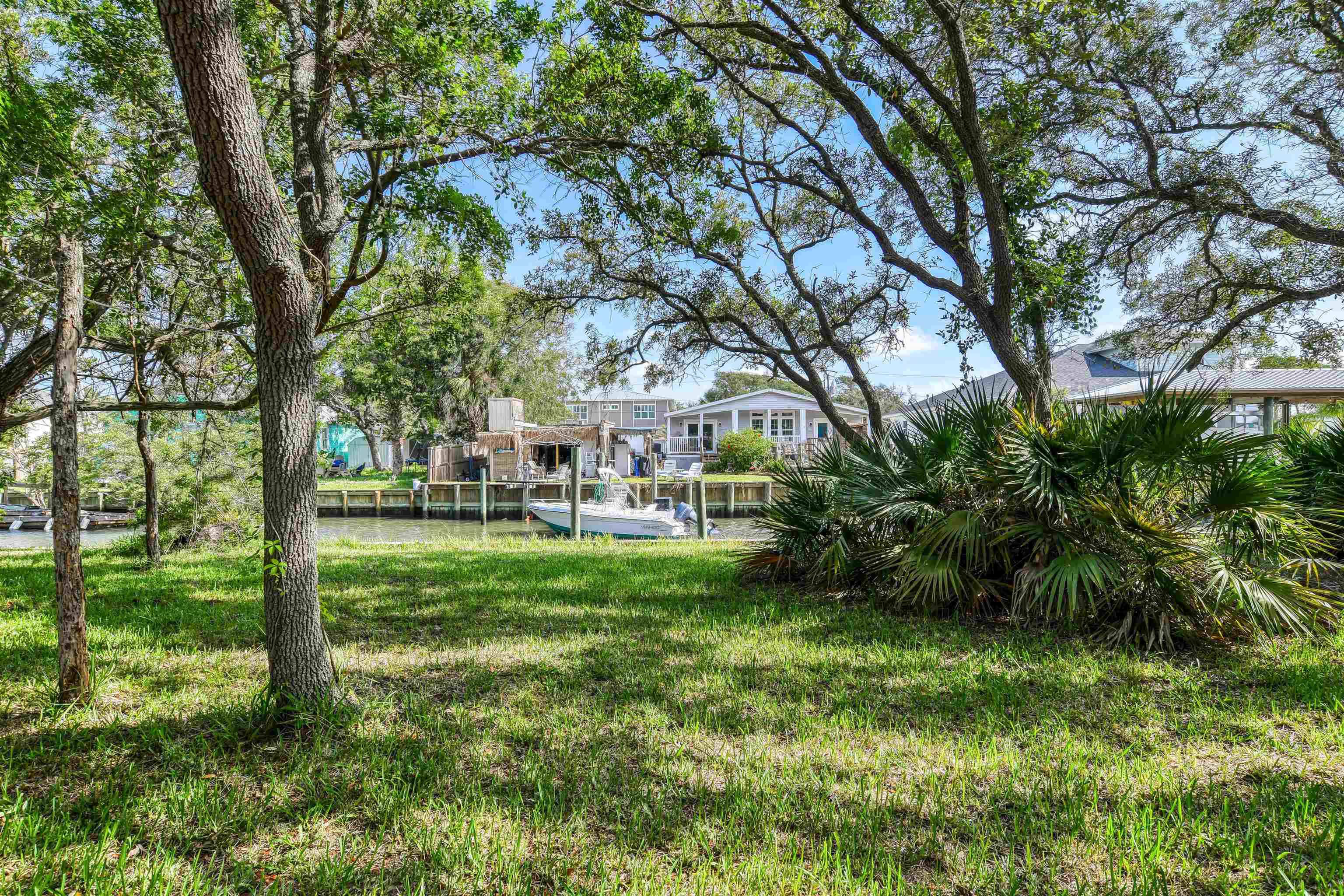 242 Basque Road St. Augustine, FL 32080 - Photo 4 of 20 a view of a yard with plants and large trees