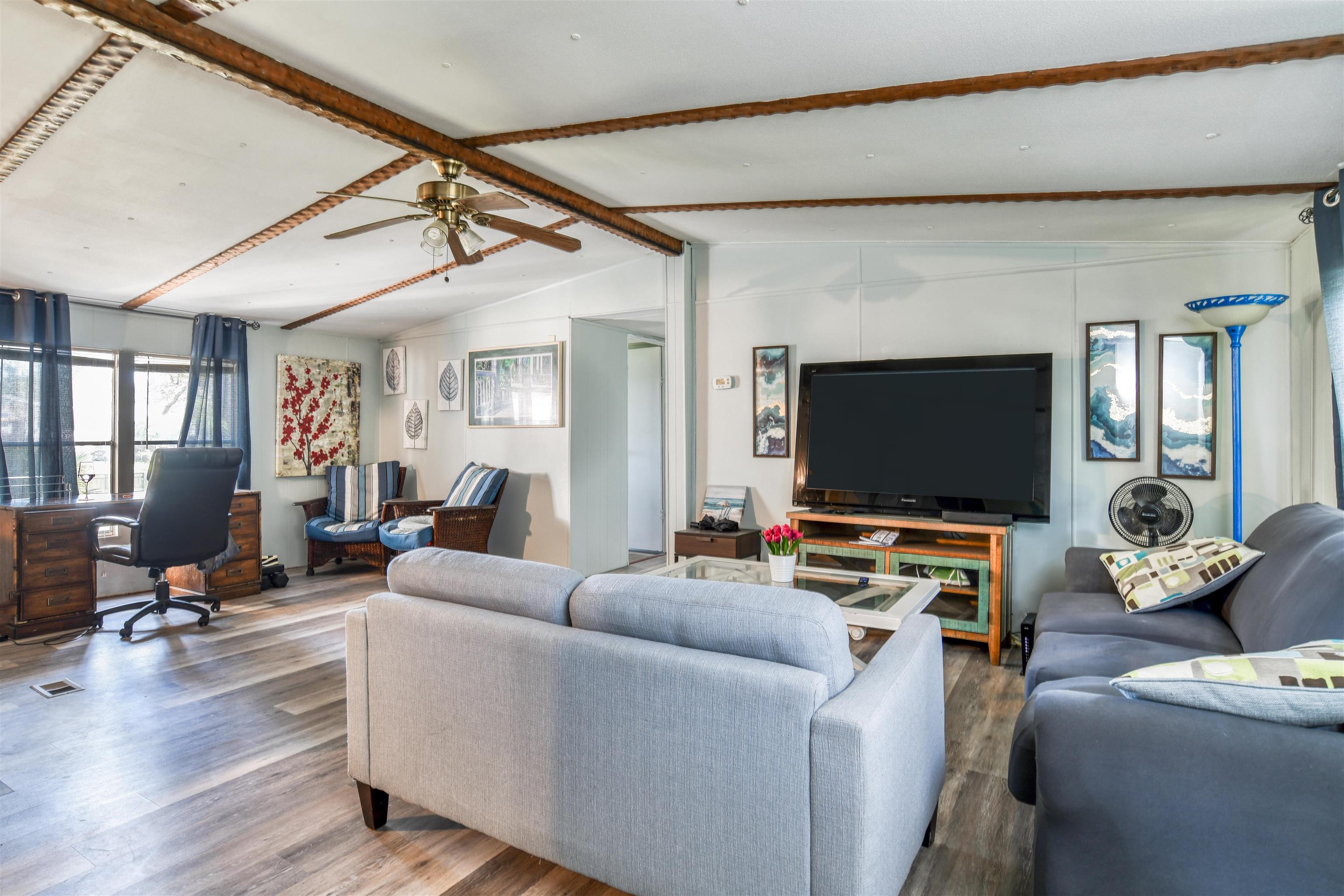 242 Basque Road St. Augustine, FL 32080 - Photo 6 of 20 a living room with furniture and a flat screen tv