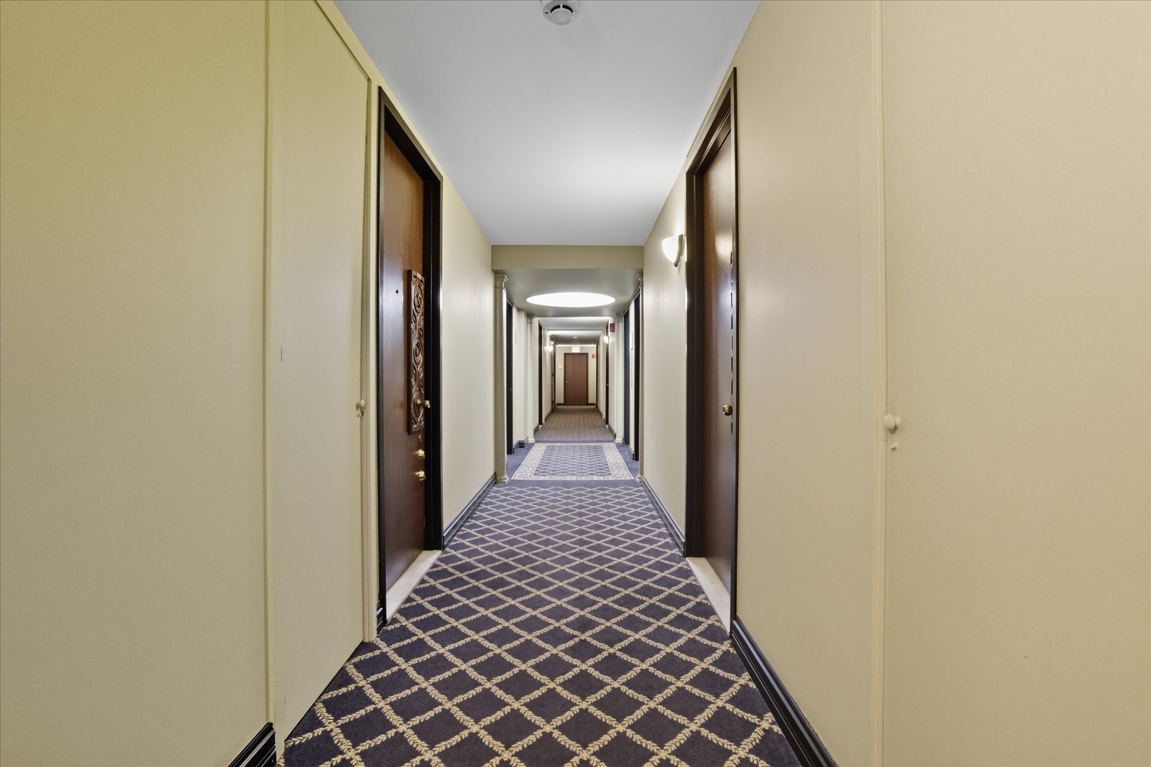 5855 North Sheridan Road, Unit 9F Chicago, IL 60660 - Photo 12 of 23 a view of a hallway with wooden floor and staircase